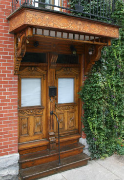 Home Facade design decoration with balcony border adorned with wood faux finish, trompel'oeil wood carving and ornament decor - Montreal.