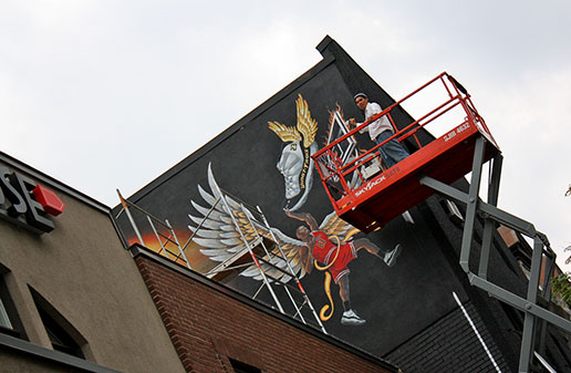 Richard Ancheta with sky jack for Michael Jordan exterior mural painting - Montreal.